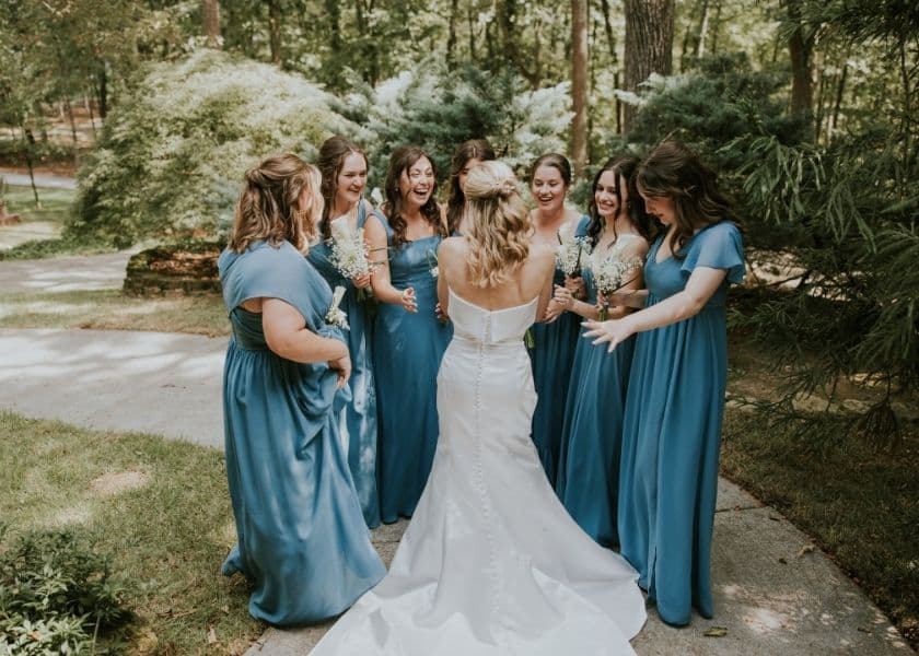 bridal party circled around bride at a microwedding bridal party circled around bride at a microwedding
