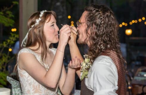 A bride and groom feeding each other a piece of cake