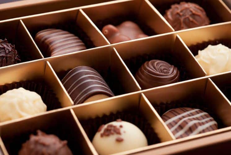 A box of gourmet chocolates of various colors and kinds