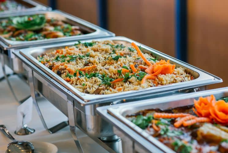 Close up view of buffet dishes in stainless steel serving containers